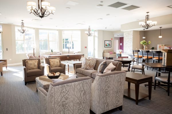 A spacious living room with comfortable seating and bright natural light.