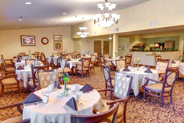 Brightly lit dining room with elegantly set tables