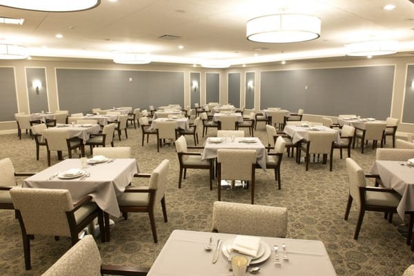 Dining area with neatly set tables and chairs