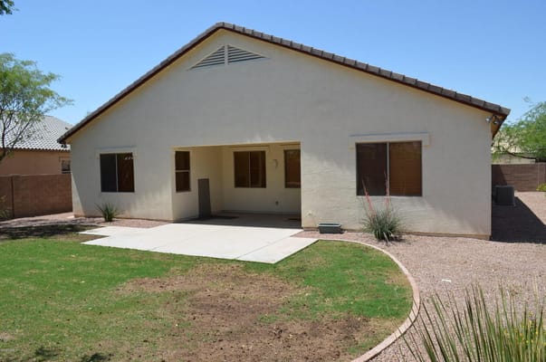 Exterior of Ur Amazing Assisted Living facility showing patio area and green lawn.