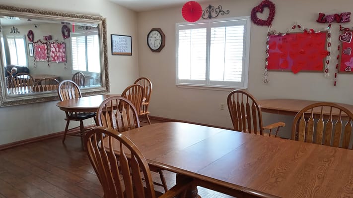 Bright common area with wooden tables and chairs