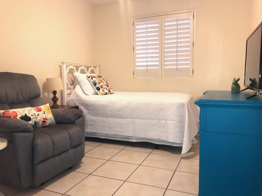 Cozy private resident room with bed and chair