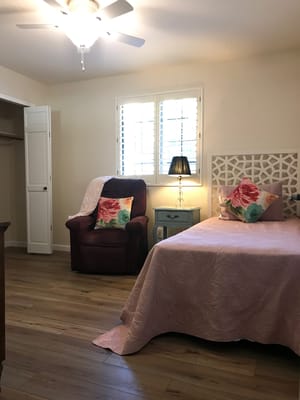Comfortable bedroom with floral decor and natural light