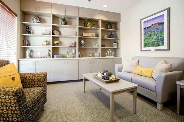 Cozy common area with seating and decorative shelves