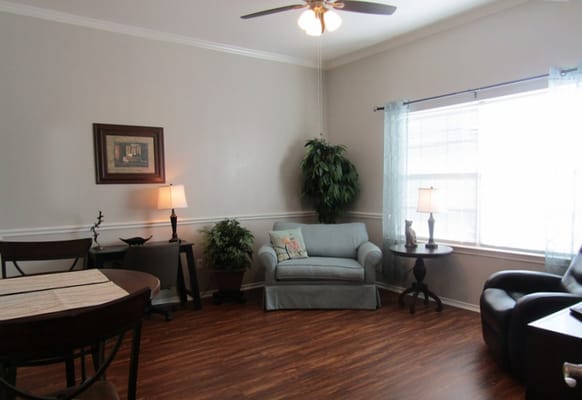 Bright living room with seating, entertainment center, and exercise equipment