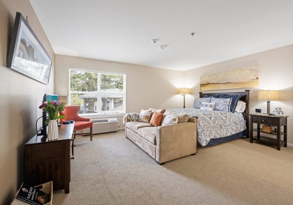 Cozy resident room with a bed and seating area