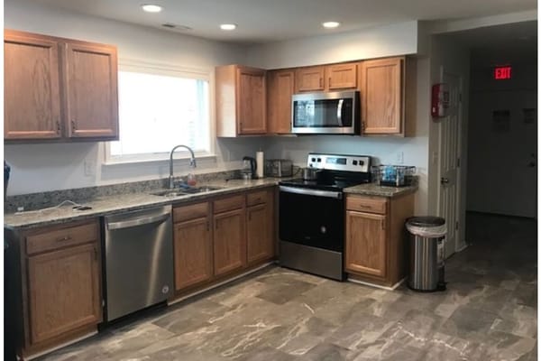 Bright kitchen with wooden cabinets and stainless steel appliances
