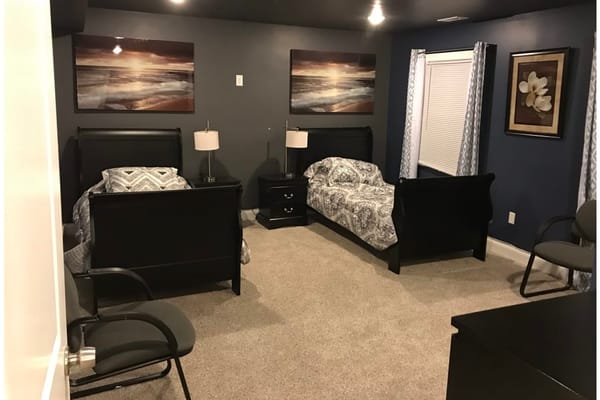 A cozy double room with two beds and decor