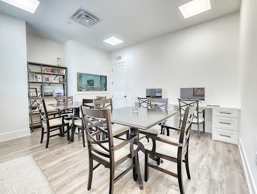 Interior of a bright common area with tables and chairs