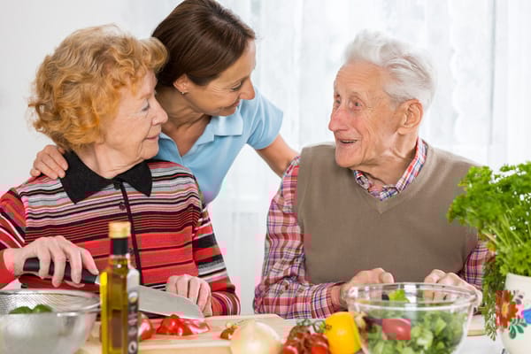 Residents and staff preparing food together
