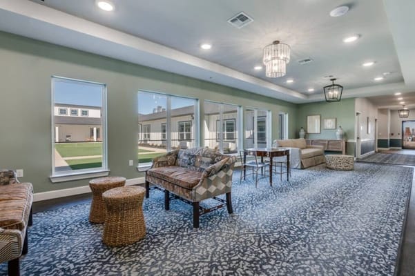 Interior of a common area with seating and large windows