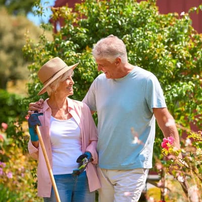 Two seniors gardening in a vibrant outdoor space