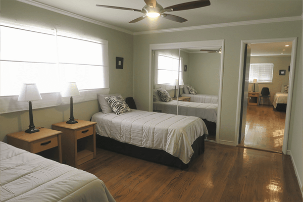 Bright resident room with twin beds and lamps