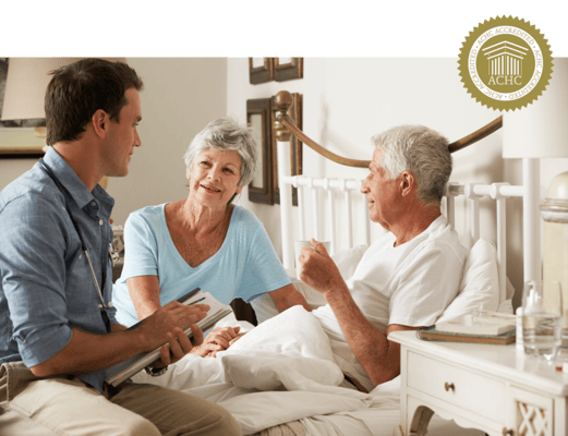 A staff member chatting with two residents in a cozy room