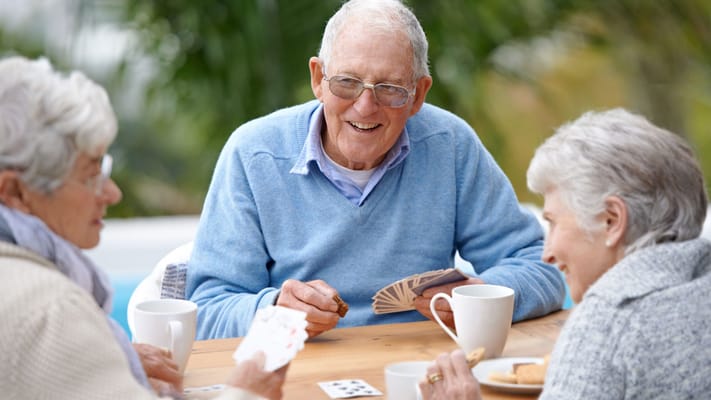 Seniors enjoying a card game outdoors