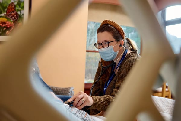 Nurse attending to a resident in a cozy room