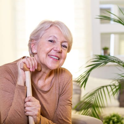 Smiling senior woman seated in a well-lit room
