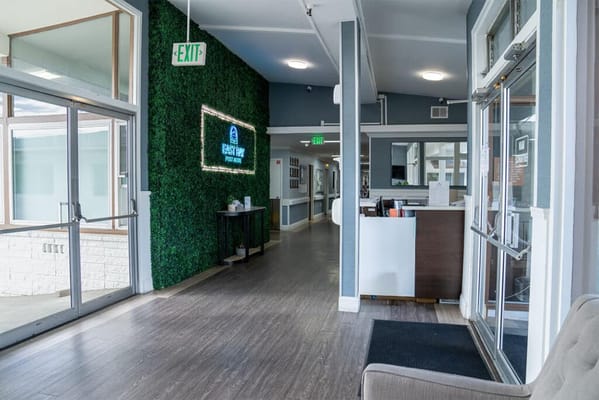 Interior view of a lobby with green wall and reception area