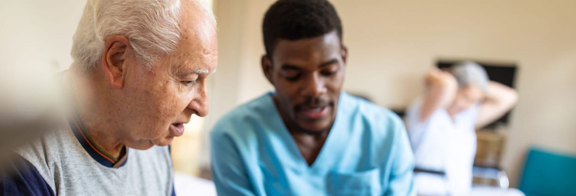 Caregiver assisting a resident in a warm environment