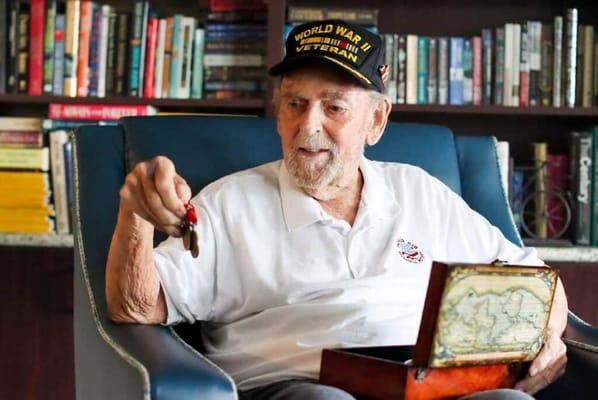 An elderly veteran reminiscing in a cozy chair