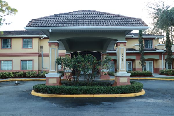 Entrance of the Wickshire Tamarac facility with landscaping