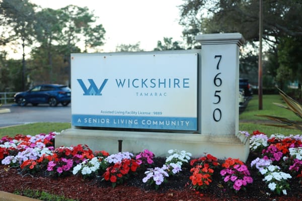 Wickshire Tamarac facility sign with flowers