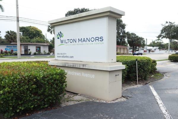 Facility entrance sign with landscaping