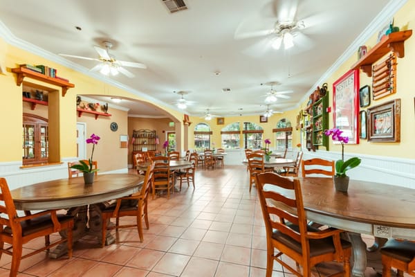 Bright common area with dining tables and decor