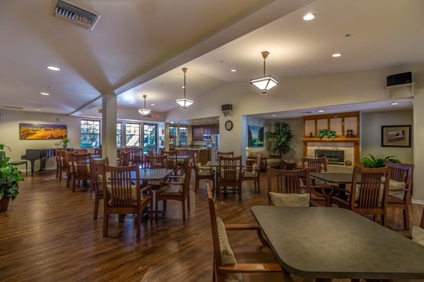 Spacious dining area with wooden tables and chairs