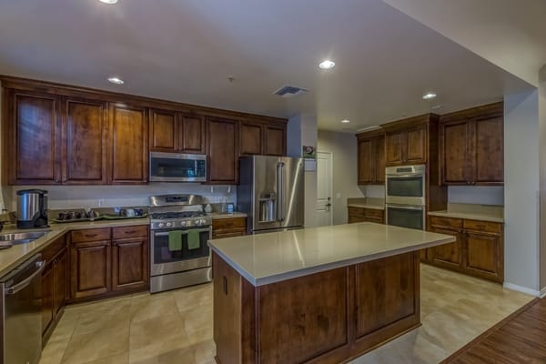 Spacious kitchen with modern appliances and wooden cabinets