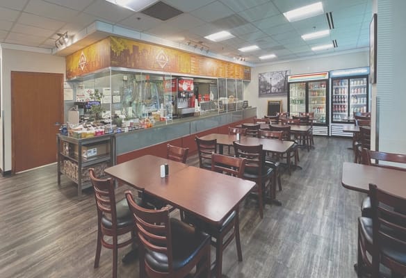 Dining area with tables and a serving counter