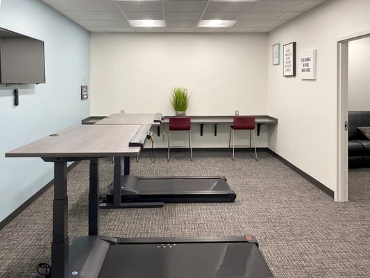 An interior fitness room with exercise equipment.
