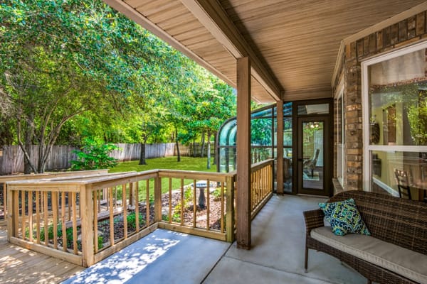 Porch with seating and lush greenery at Hillside Assisted Living