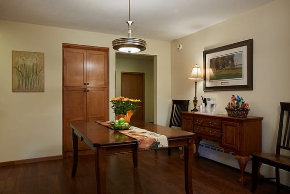 Bright dining area with wooden furniture and decorations