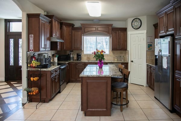 A modern kitchen with wooden cabinets and an island