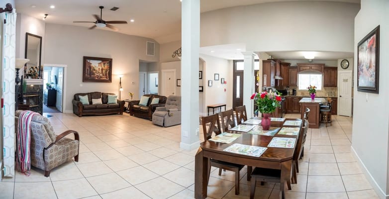 Bright common area with a dining table and seating