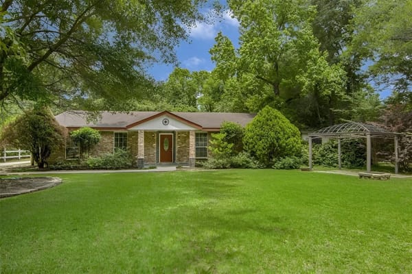 Exterior view of Acorn Manor Assisted Living surrounded by greenery