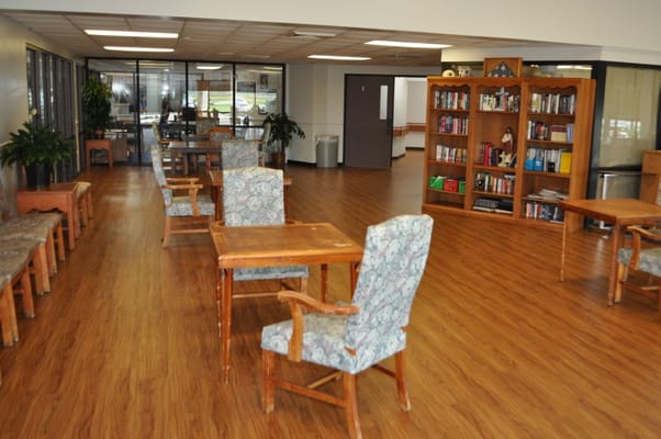 Bright interior of a common area with seating and bookshelves