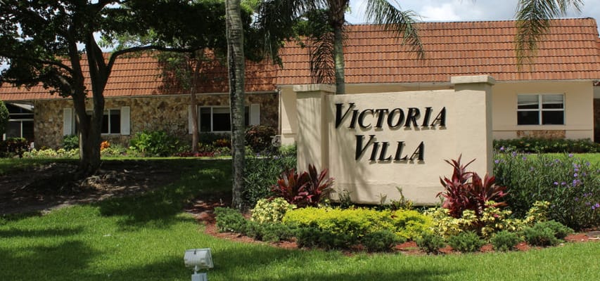 Exterior view of Victoria Villa facility sign and landscaping