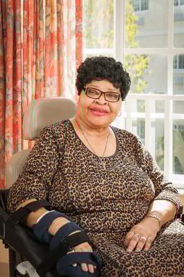 A resident posing in a brightly lit room