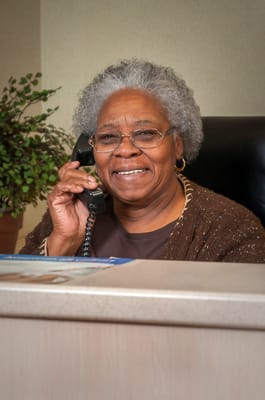 Receptionist smiling at the front desk