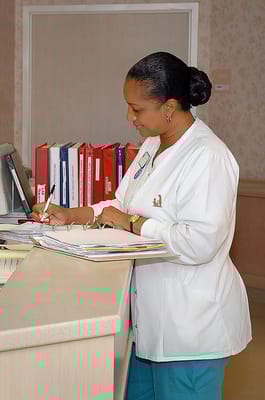 Staff member attending to paperwork at the reception