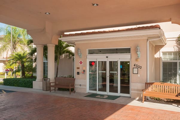 Entrance of Life Care Center at Inverrary with benches