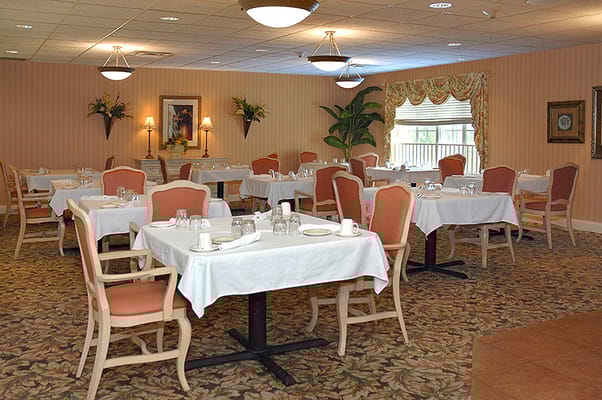 Dining area with neatly set tables and chairs