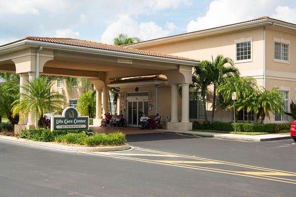 Entrance of Life Care Center at Inverrary with residents
