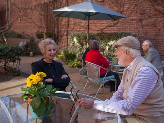 Residents chatting outdoors in a garden area