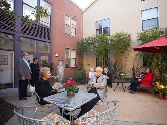 Residents enjoying time in a garden courtyard area