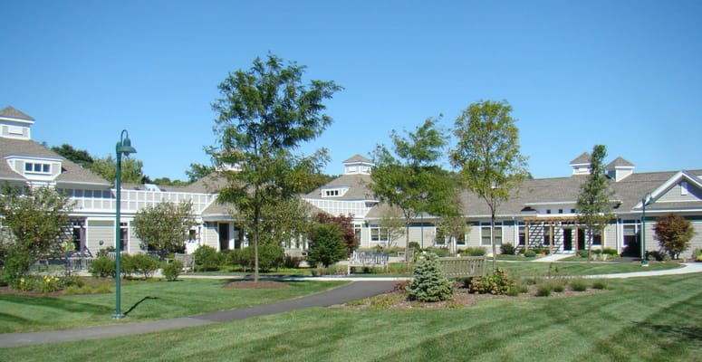 Outdoor view of a senior living facility with gardens and paths