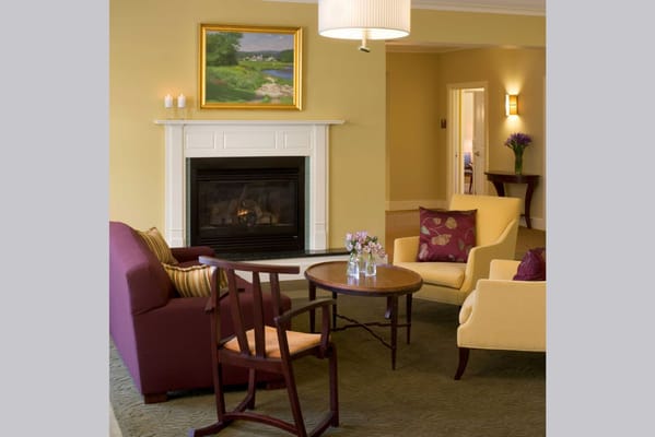 Cozy interior seating area with fireplace and artwork