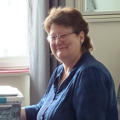 Resident smiling in a bright indoor space